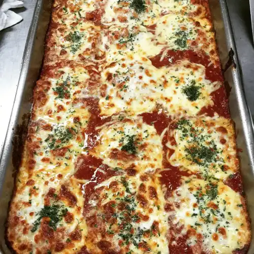 Golden-Crusted Gluten-Free Eggplant Parmesan with Herbed Cashew Crust - Eggplant parmesan by adobo express is licensed under CC BY 2.0.
