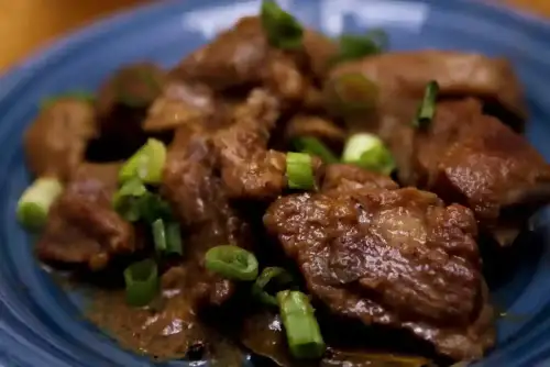 Gluten-Free Filipino Adobo: A Timeless Dish Reimagined - Pork adobo with shallots by pulaw is licensed under CC BY 2.0.