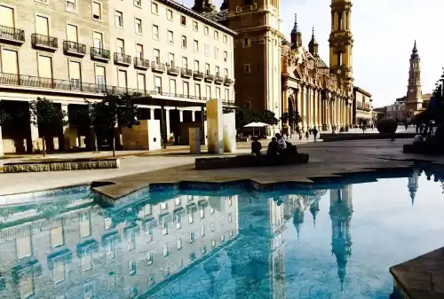 Traveling to Spain with Celiac Disease: A Gluten-Free Guide - Plaza de Pilar Zaragoza #iphone #Spain# #reflections by Leshaines123 is licensed under CC BY 2.0.